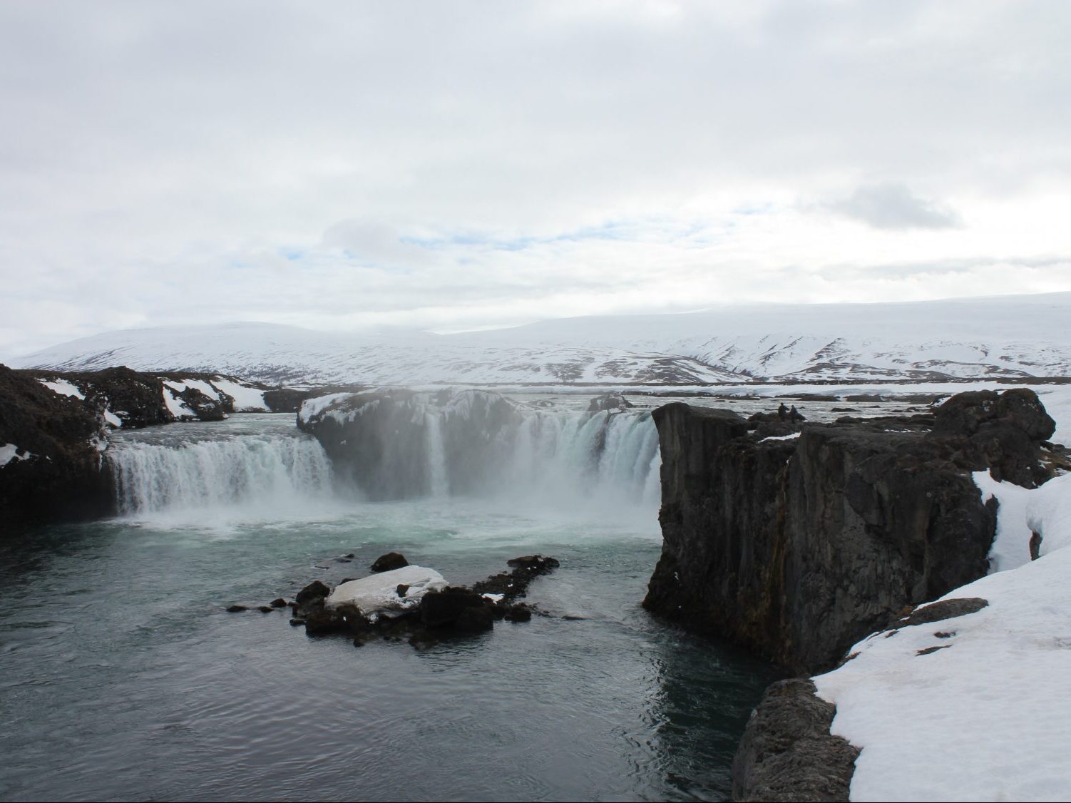 waterfall surrounded by snow in Godafoss, Iceland