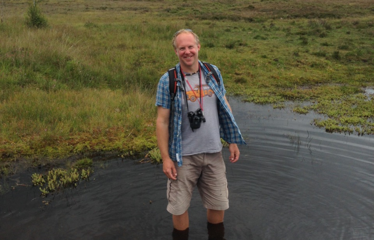 Wildlife Travel leader Dominic Price standing in a bog